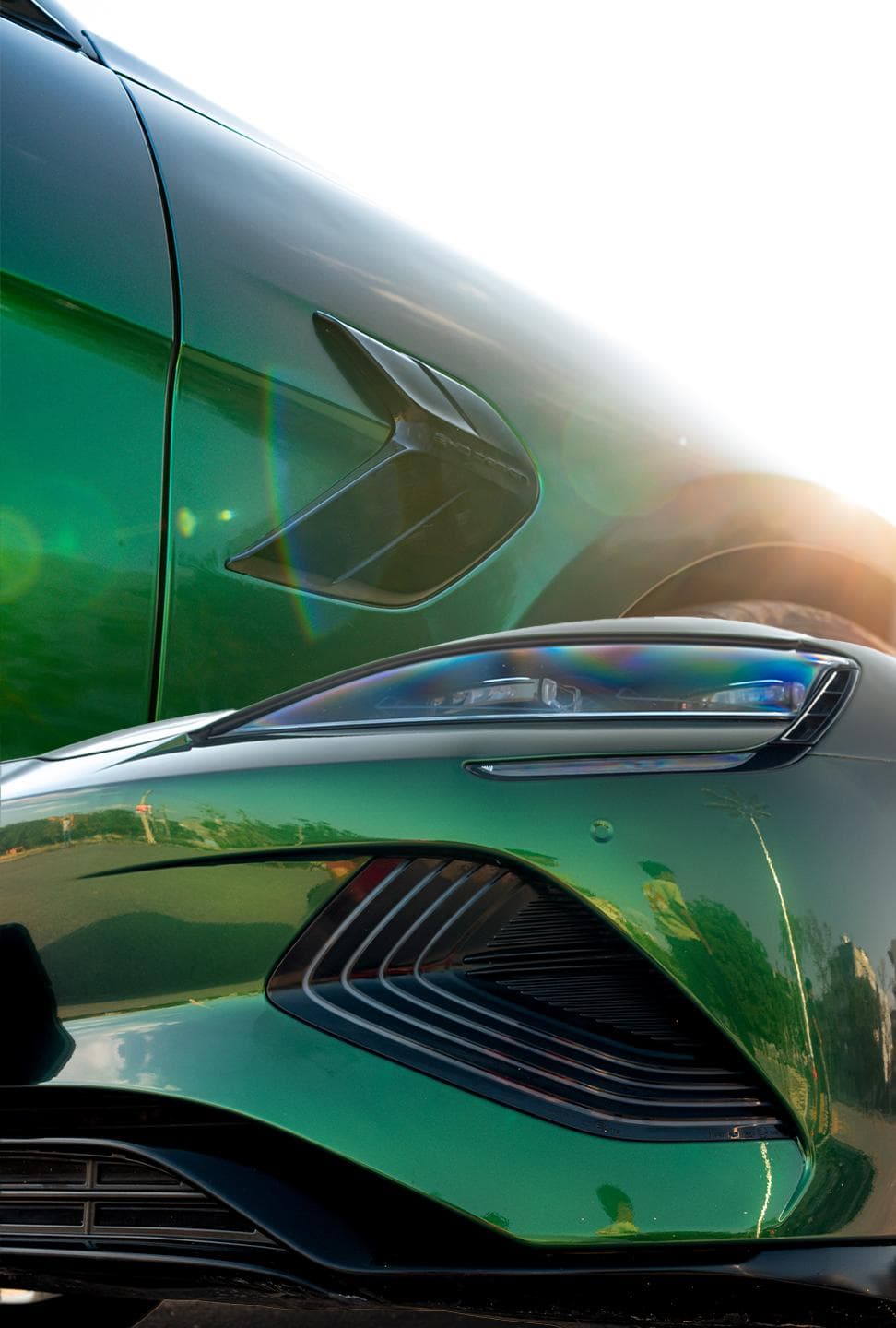 Colored paint protection film in green on a car's headlight and fender