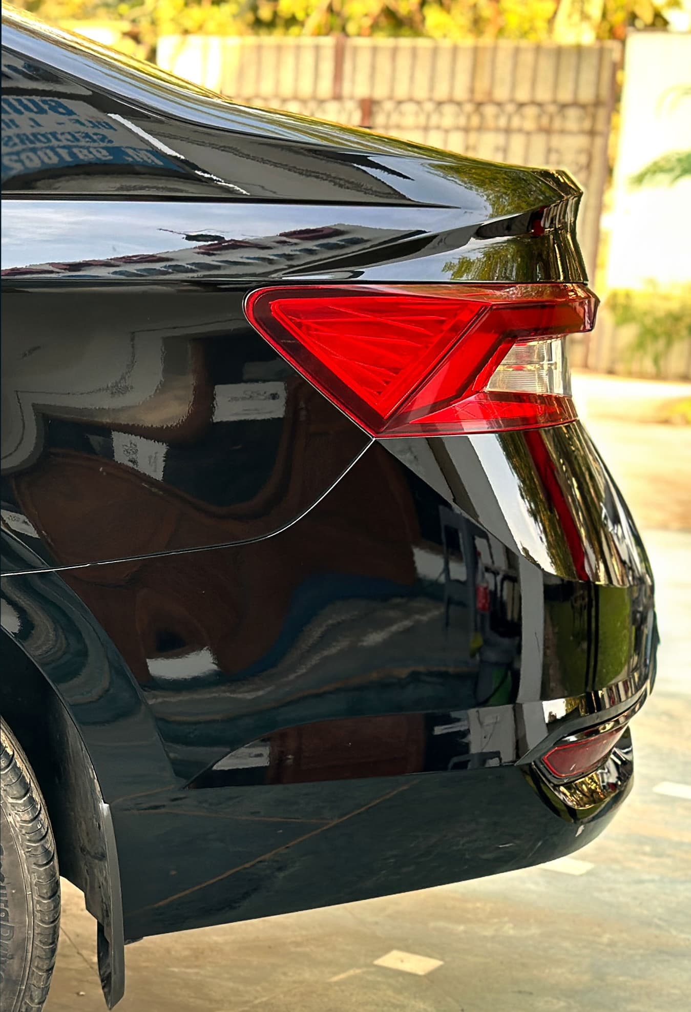Gloss black paint protection film on a car's taillight and rear quarter panel