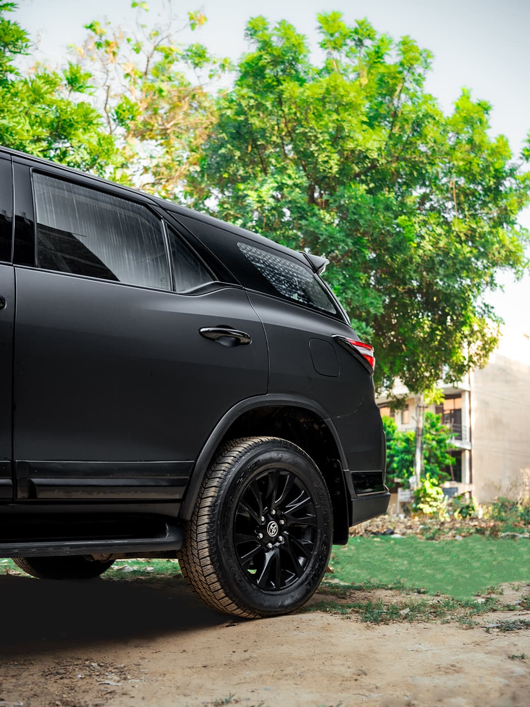 Matte black paint protection film on an SUV's rear door and quarter panel